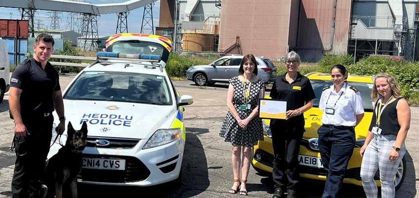 Staff with police dog and certificate 