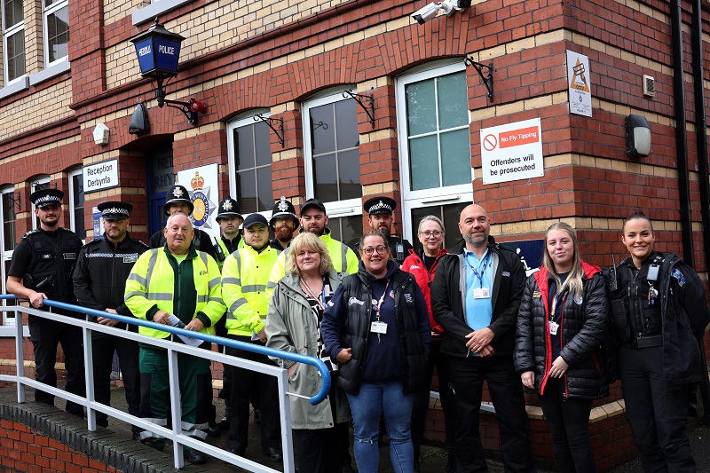 Group of people lined up outside police station