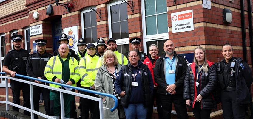 Group of people lined up outside police station