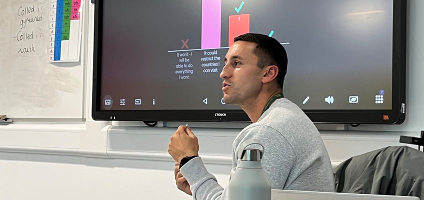 Youth offending service worker in front TV screen showing the question: How can having a criminal record affect your future?