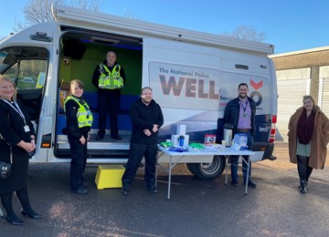 Police officers and support staff outside van