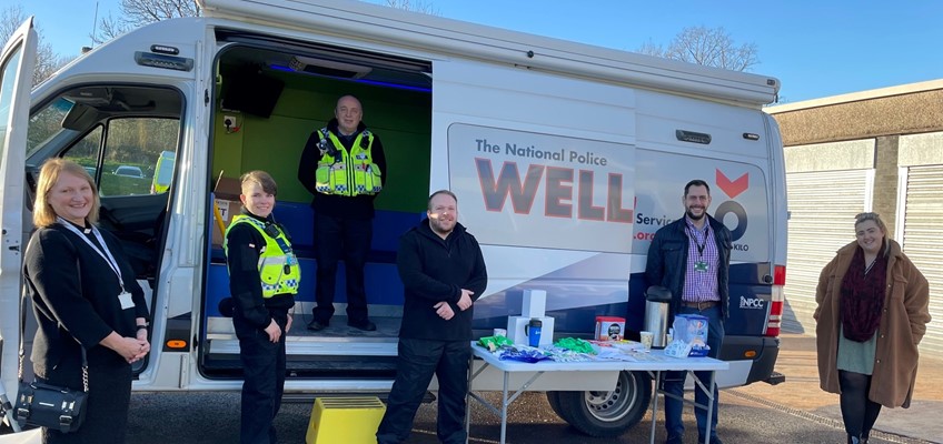 Police officers and support staff outside van