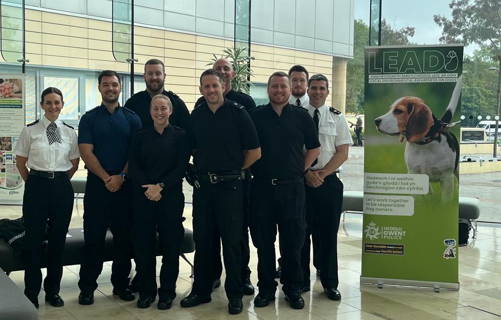 Police officers standing next to LEAD banner