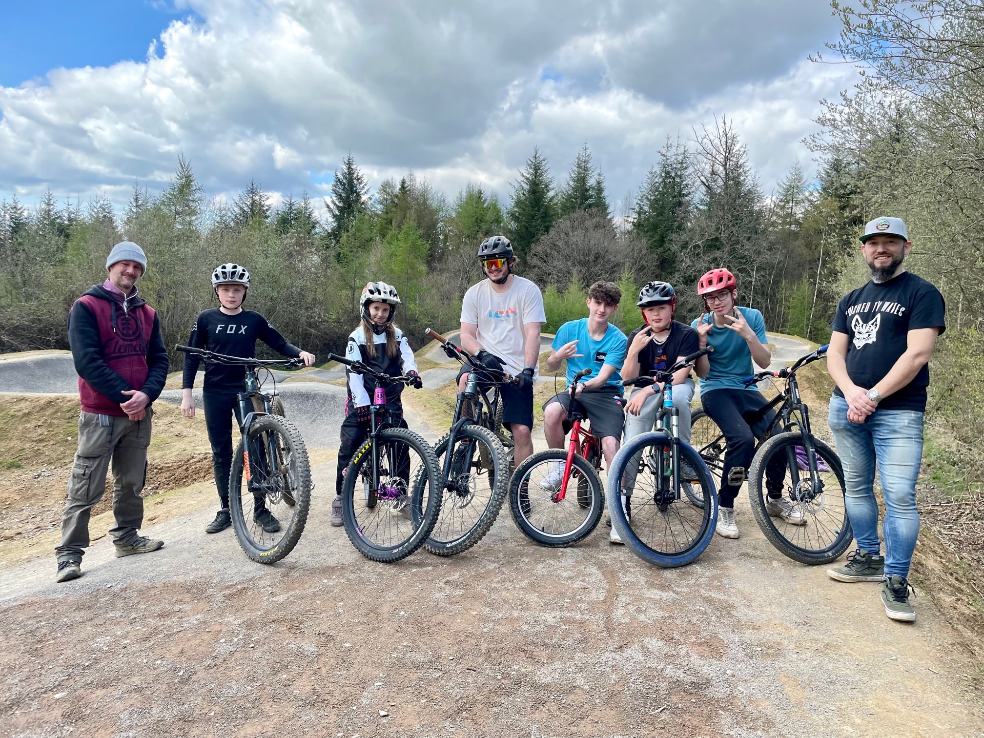 Group of riders in front of pump track