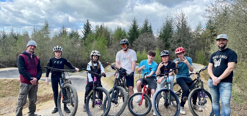 Group of riders in front of pump track