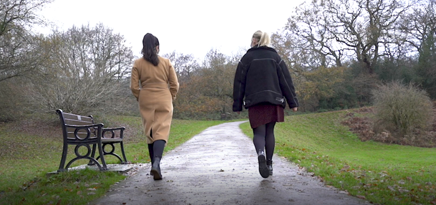 two women walking along path