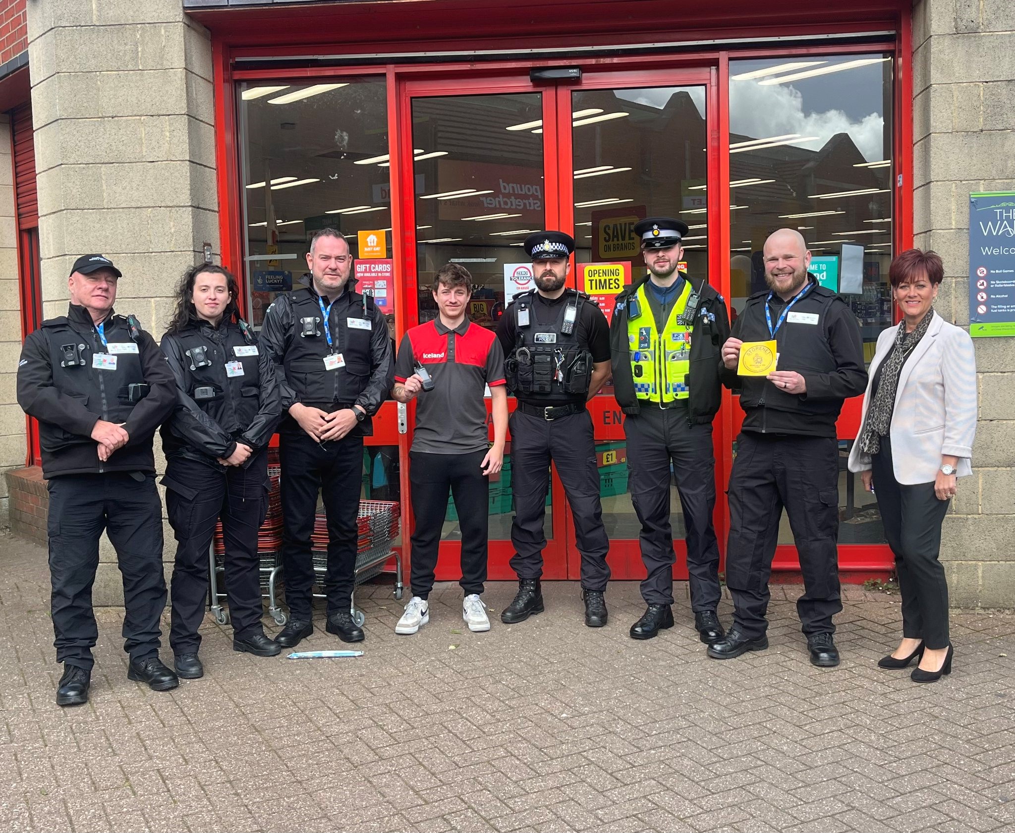 Police officers and council staff with retail workers