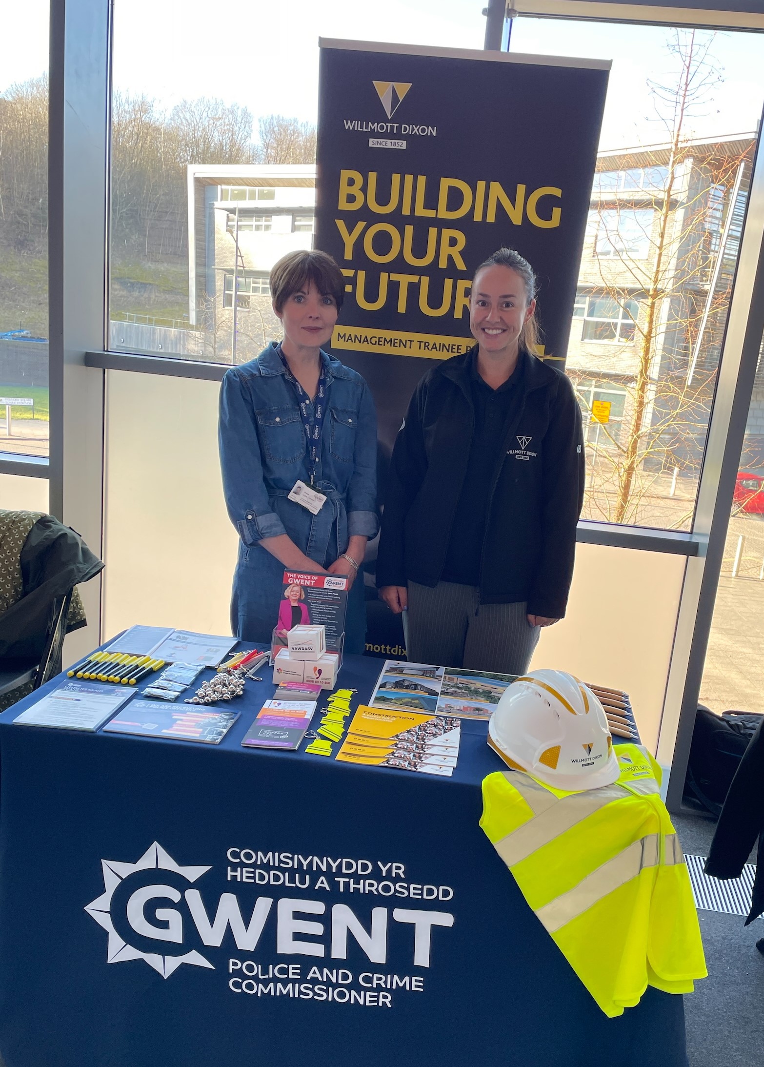 Staff members stood in front of banner