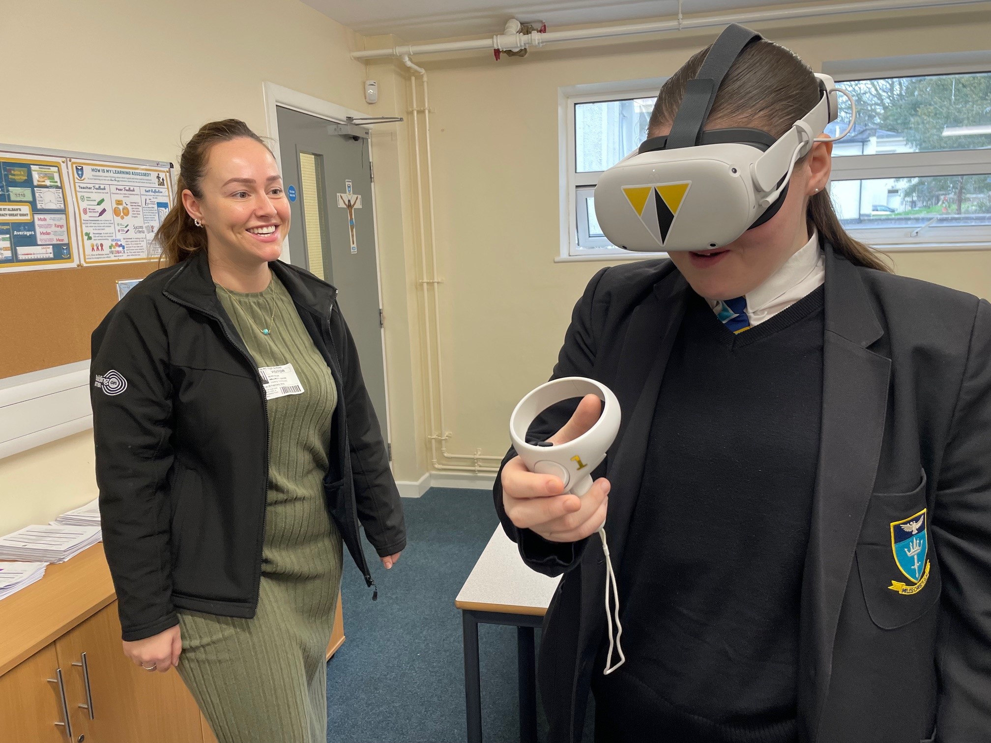 Representative from Willmott Dixon with girl wearing VR headset