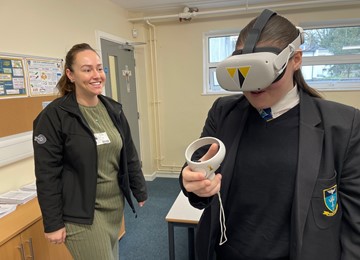 Representative from Willmott Dixon with girl wearing VR headset