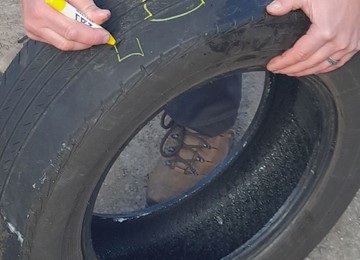 tyre being marked with yellow crayon