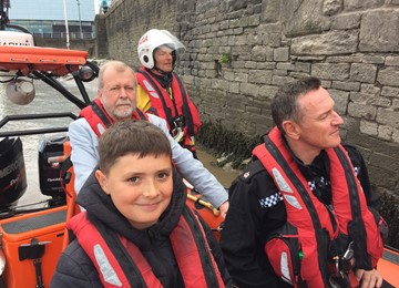 Jeff Cuthbert on a lifeboat with crew