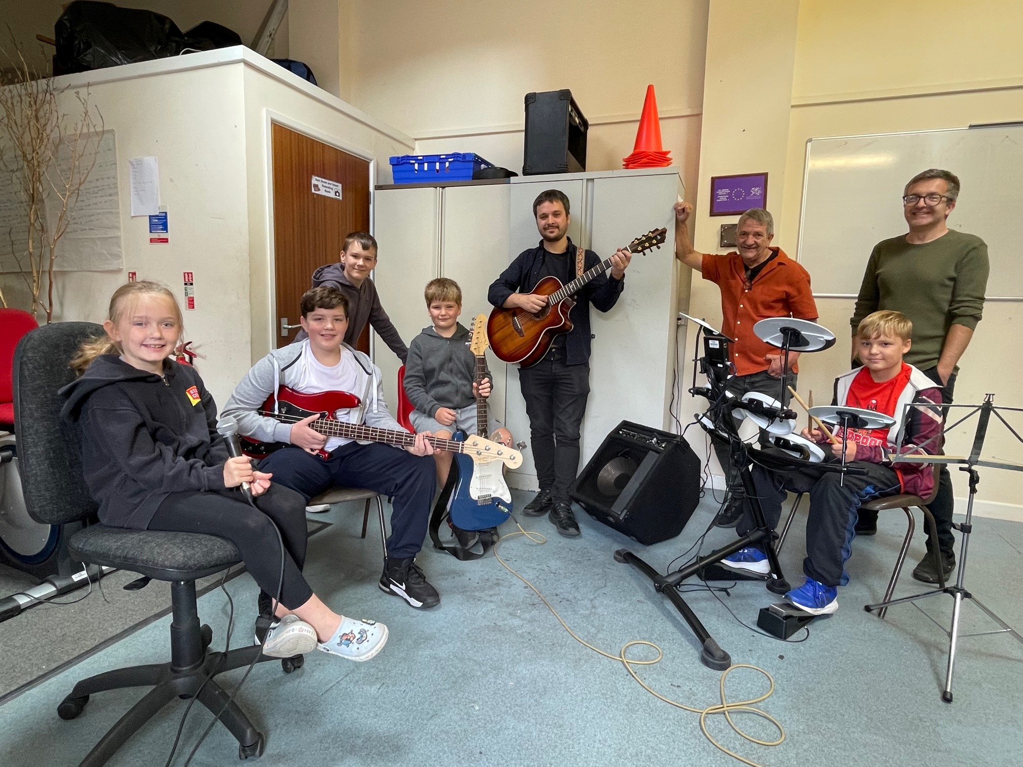 Children and youth workers holding instruments 