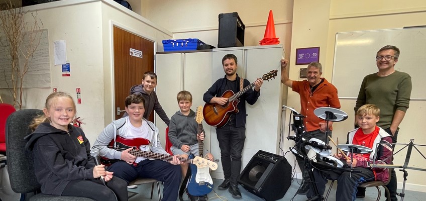 Children and youth workers holding instruments