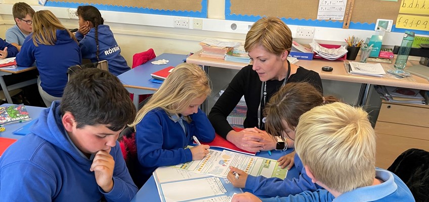Member of the OPCC talking to children who are completing surveys