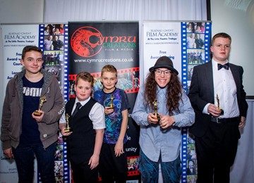 group of young people holding awards