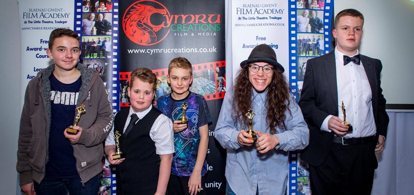 group of young people holding awards