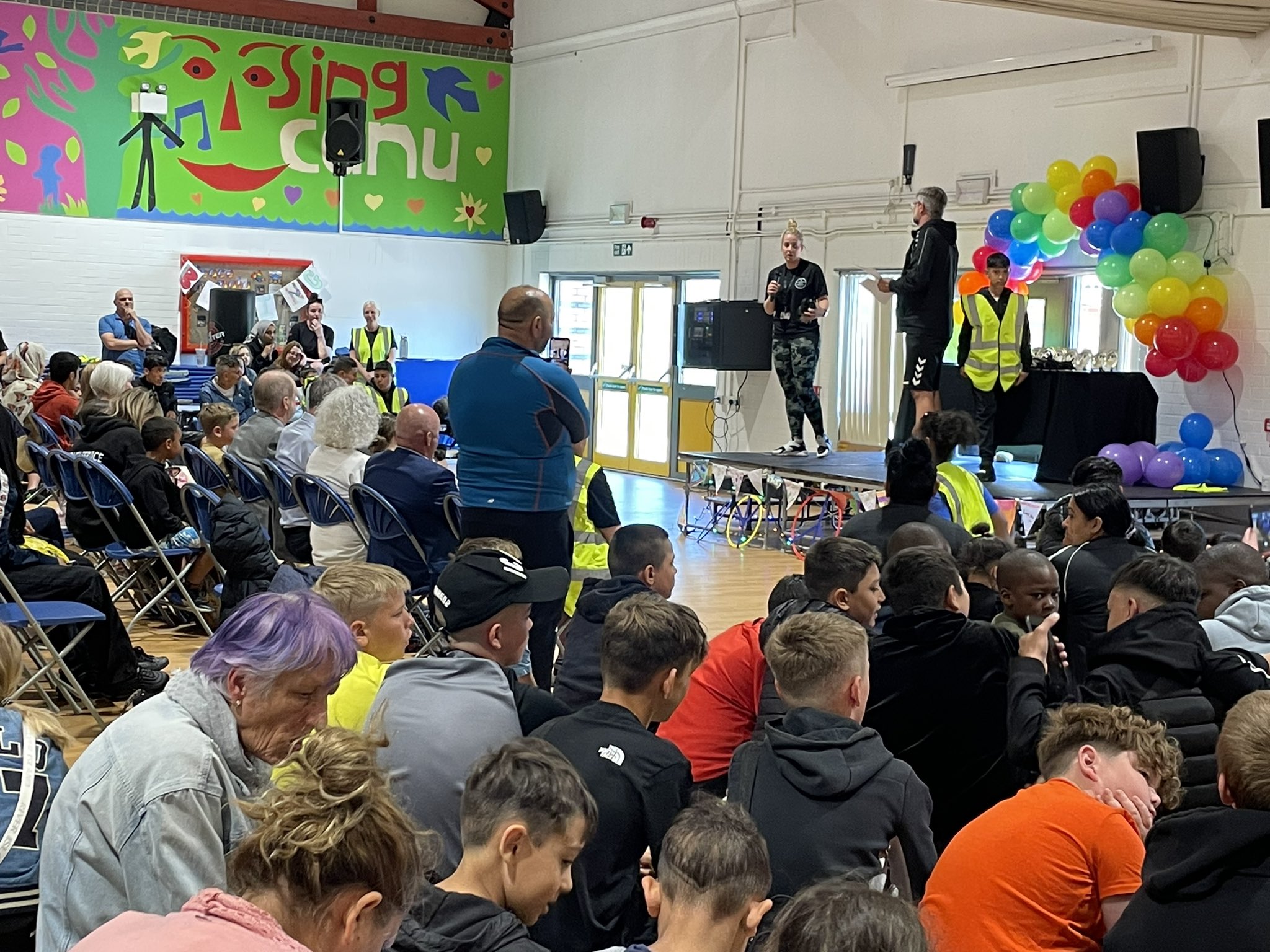 People sat watching compare on stage